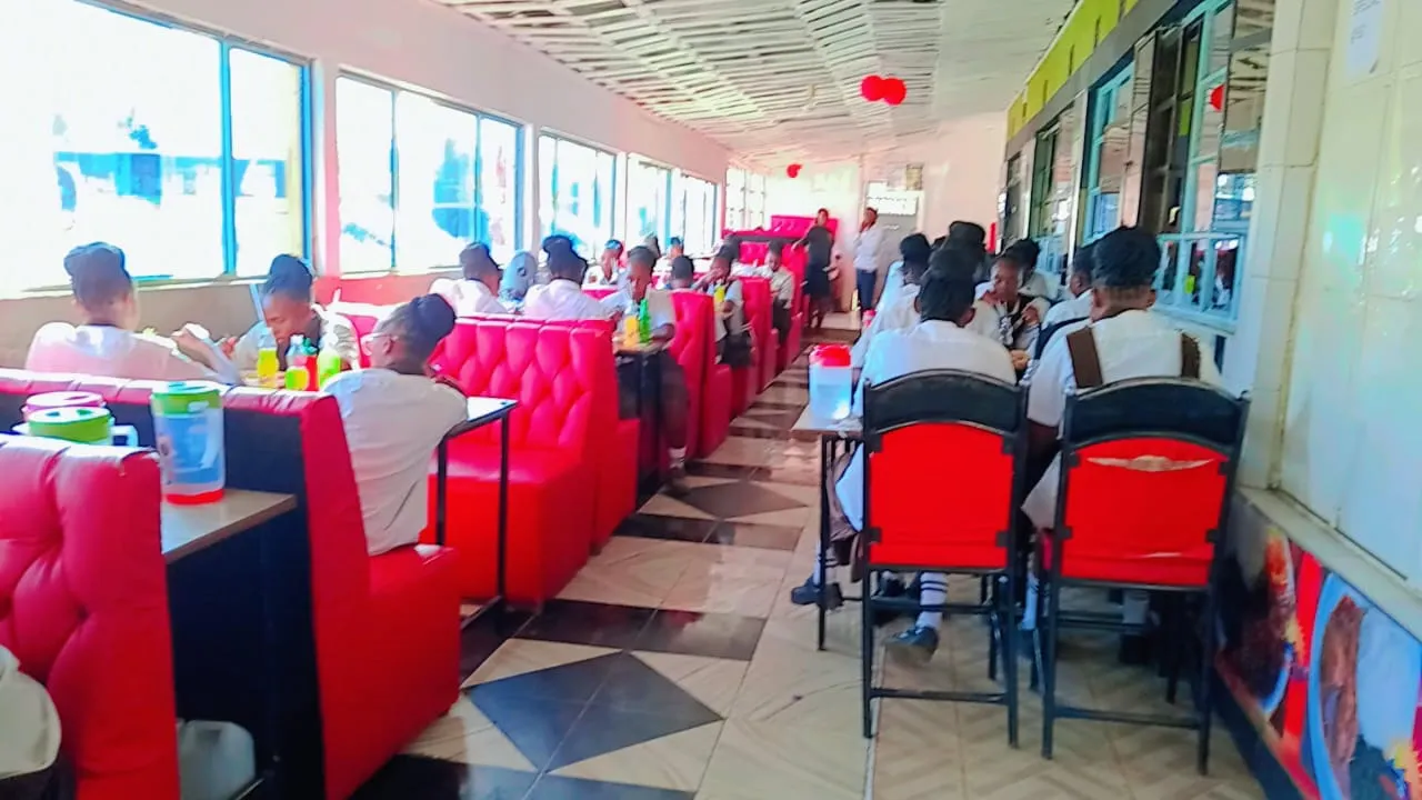 Students seated at the red booths inside Mwangaza Hotel (Railways)
